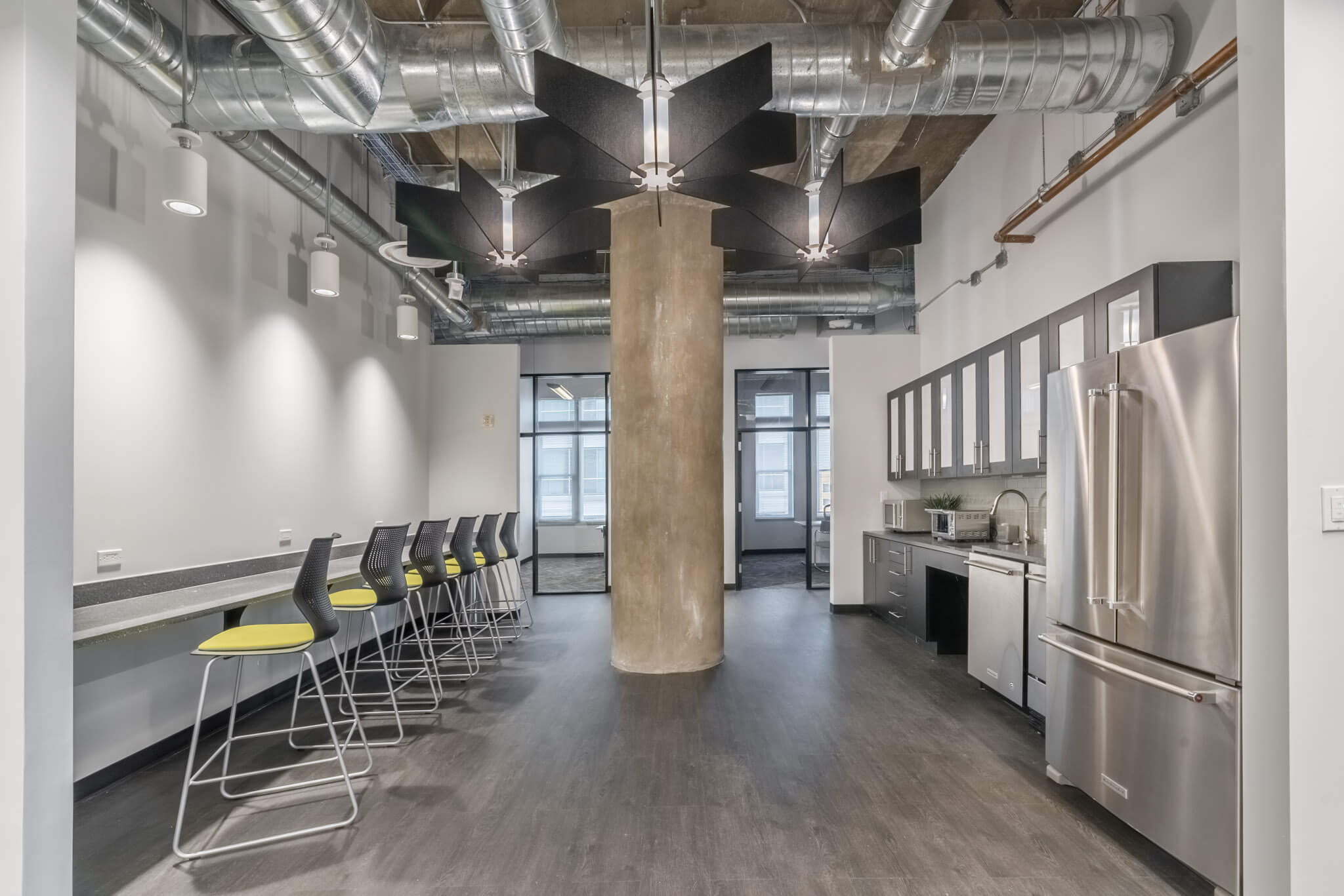 A long room with chairs and tables in it