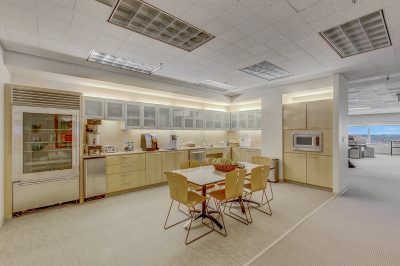 A kitchen with many cabinets and tables in it