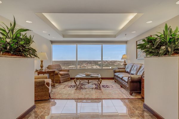 A living room with a large window and a couch