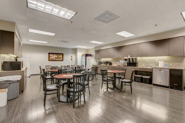 A large room with many tables and chairs.